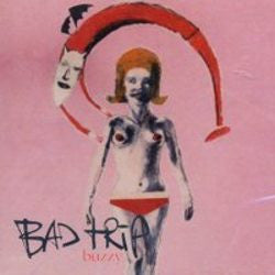 The image features the album cover of "Bad Trip – Buzzy, Wreck-Age – WAR022-1, US 1995" Factory Sealed Vinyl LP. The artwork is bold and artistic, portraying a pink-hued background with a striking depiction of a woman's face and upper body, stylized in a pop art style.