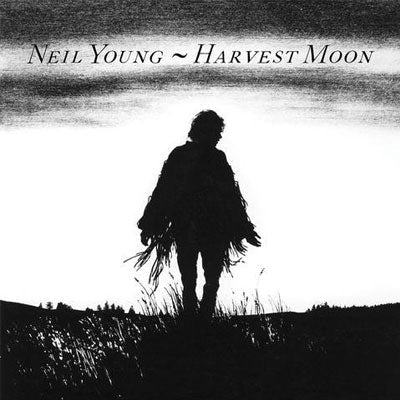 Black and white cover art for Neil Young album Harvest Moon, featuring a silhouette of Neil Young walking in a field