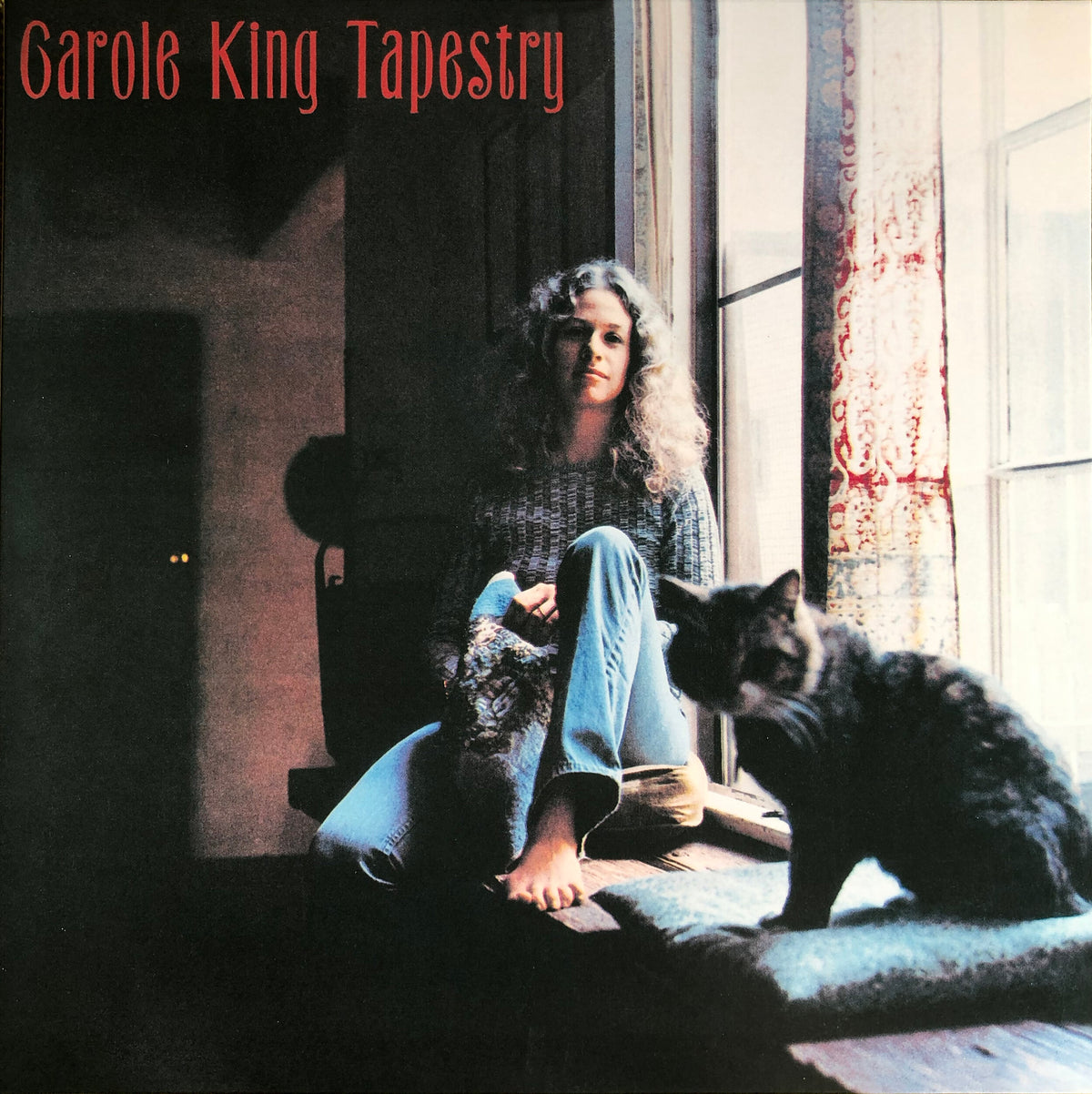 Tapestry by Carole King shows Carole, sitting on a windowsill with her cat beside her, looking towards the camera.