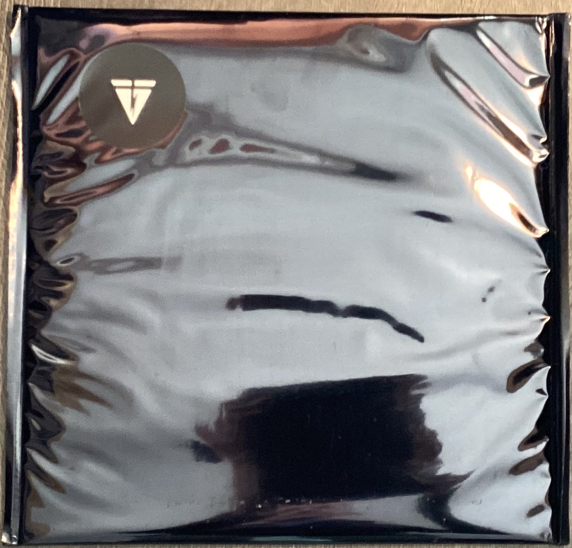 oversized black metallic photographic bags with Tape Loop Orchestra logo on the top corner.