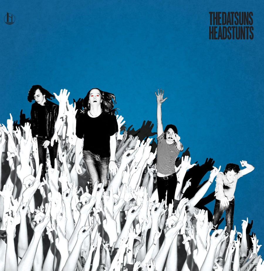 A vinyl LP cover of The Datsuns - Headstunts, featuring a black and white photo of the band members on a blue background