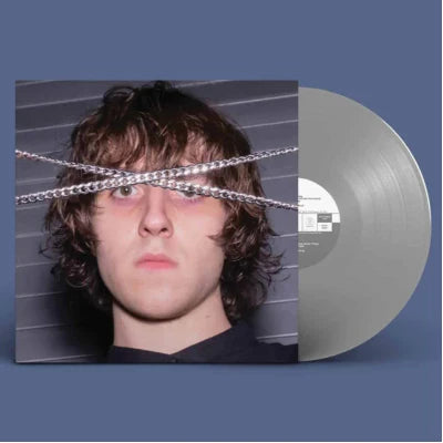 Vinyl record with a cover featuring a person's face and chain design on a blue background
