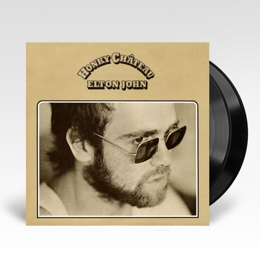 Elton John's 'Honky Chateau' album cover, featuring a black and white photo of Elton John wearing sunglasses with the album title text above.