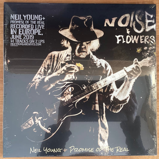 A black and white image of Neil Young playing a guitar on the album cover for 'Noise & Flowers'