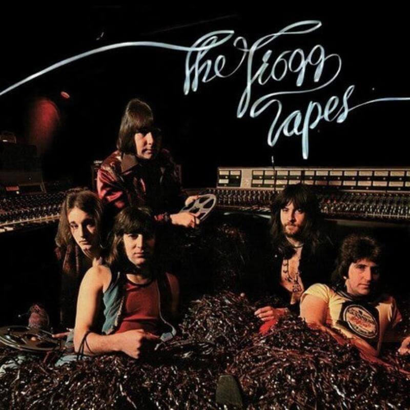 The image shows the cover of a vinyl LP titled 'The Troggs Tapes'. The band members are seated on a floor in a studio setting, with unravelled tape covering them